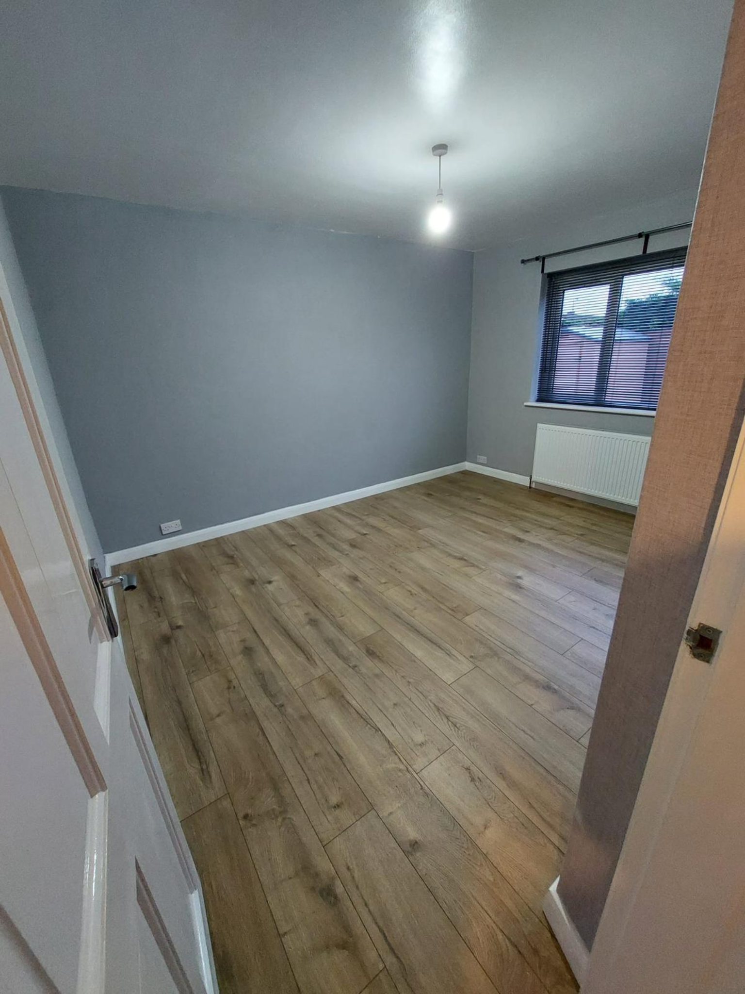 Wide view of finished flooring project in empty room